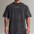 Man wearing black oversized Lift Big fitness t-shirt, gym apparel, tattooed arm visible