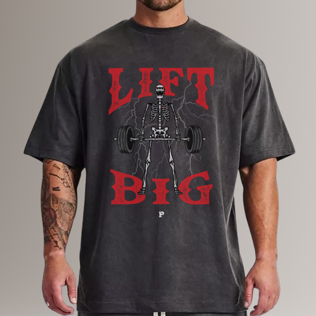 Man wearing black oversized fitness t-shirt with skeleton lifting barbell and red 'Lift Big' text