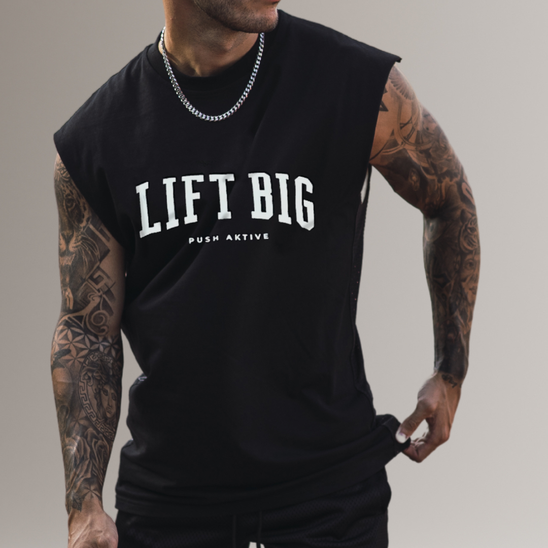 Person wearing a black sleeveless shirt with 'LIFT BIG' text on a plain background