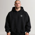 Man wearing a black hoodie with 'Lift Big' text on a plain background