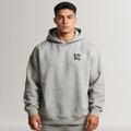 Person wearing a gray hoodie with 'Lift Big' text on a plain background