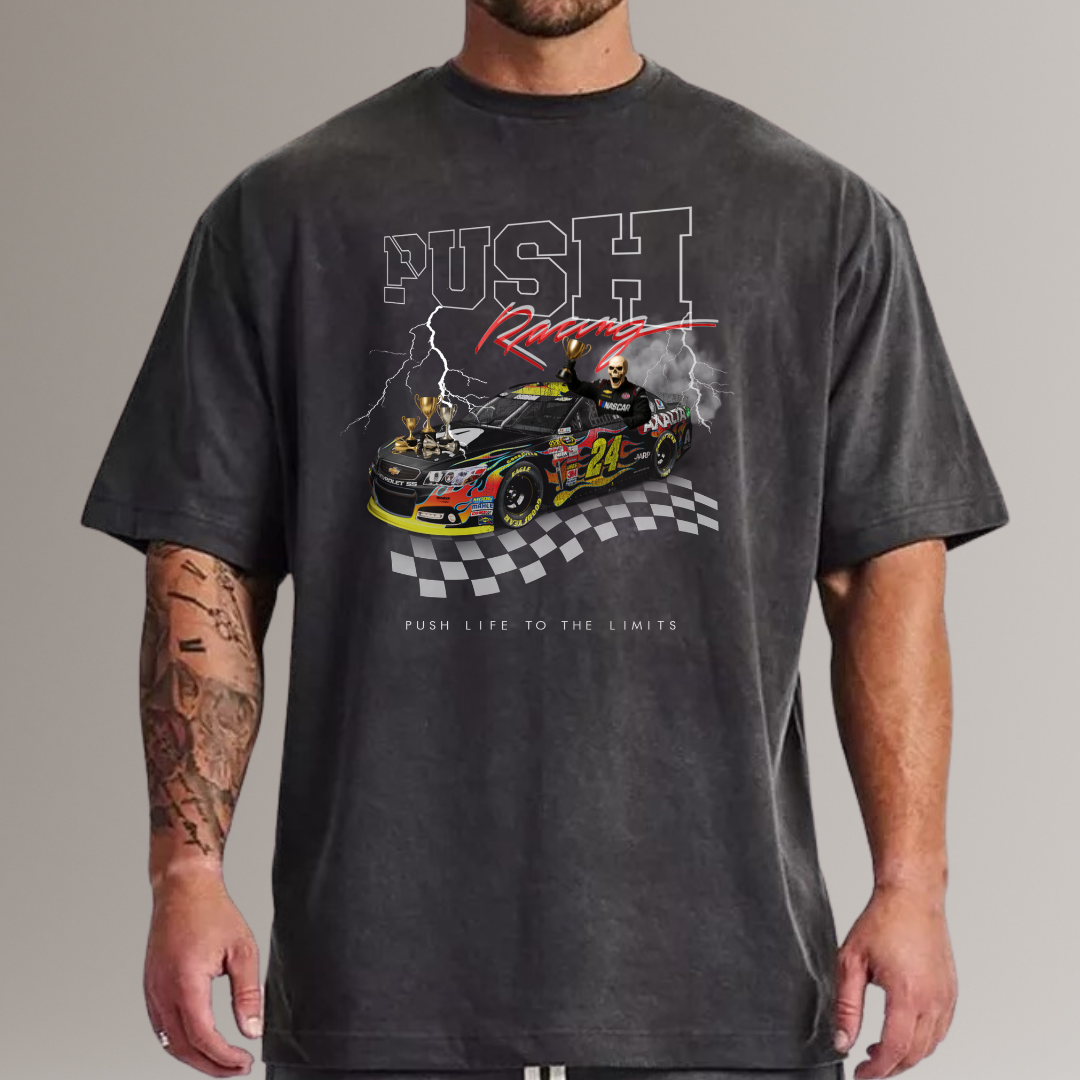 Person wearing a black t-shirt with a racing graphic and text on a gray background