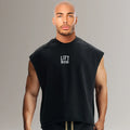 Man wearing black sleeveless gym shirt with 'LIFT BIG' text, fitness apparel